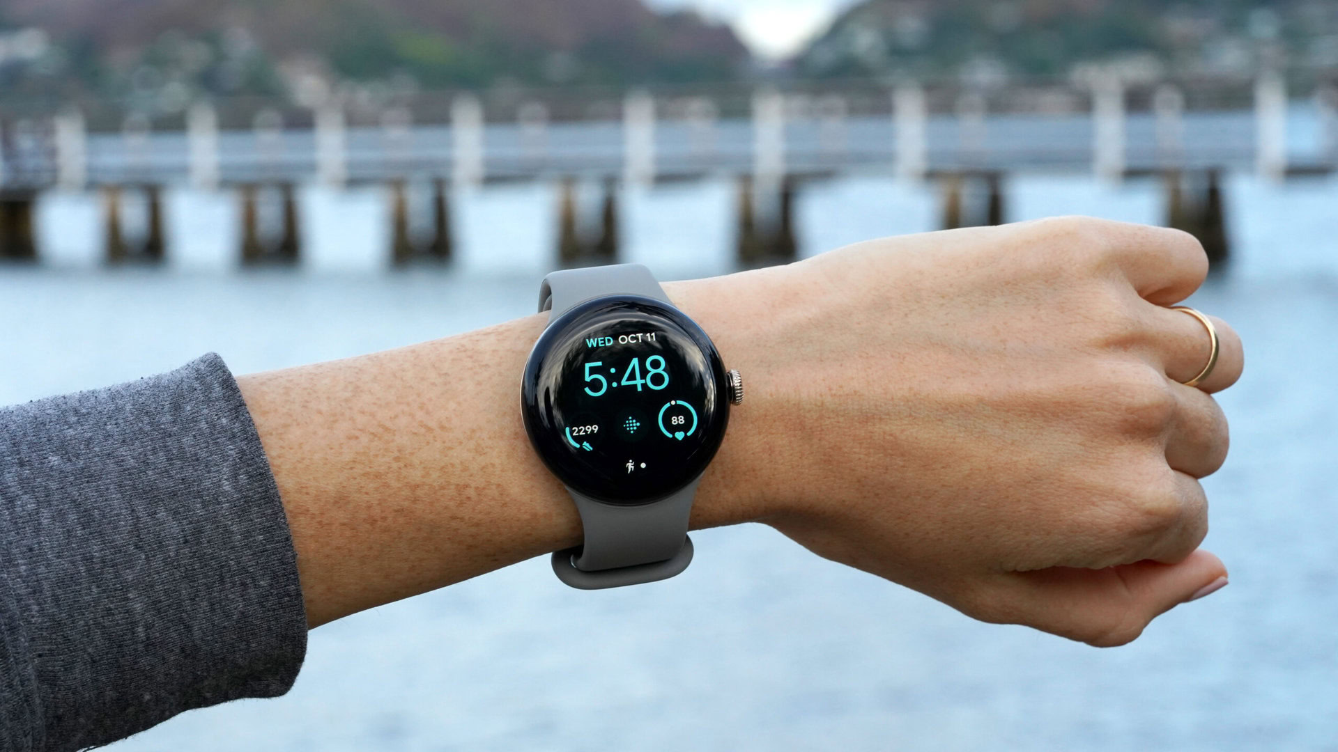 A Google Pixel Watch 2 displays the Utility watch face.