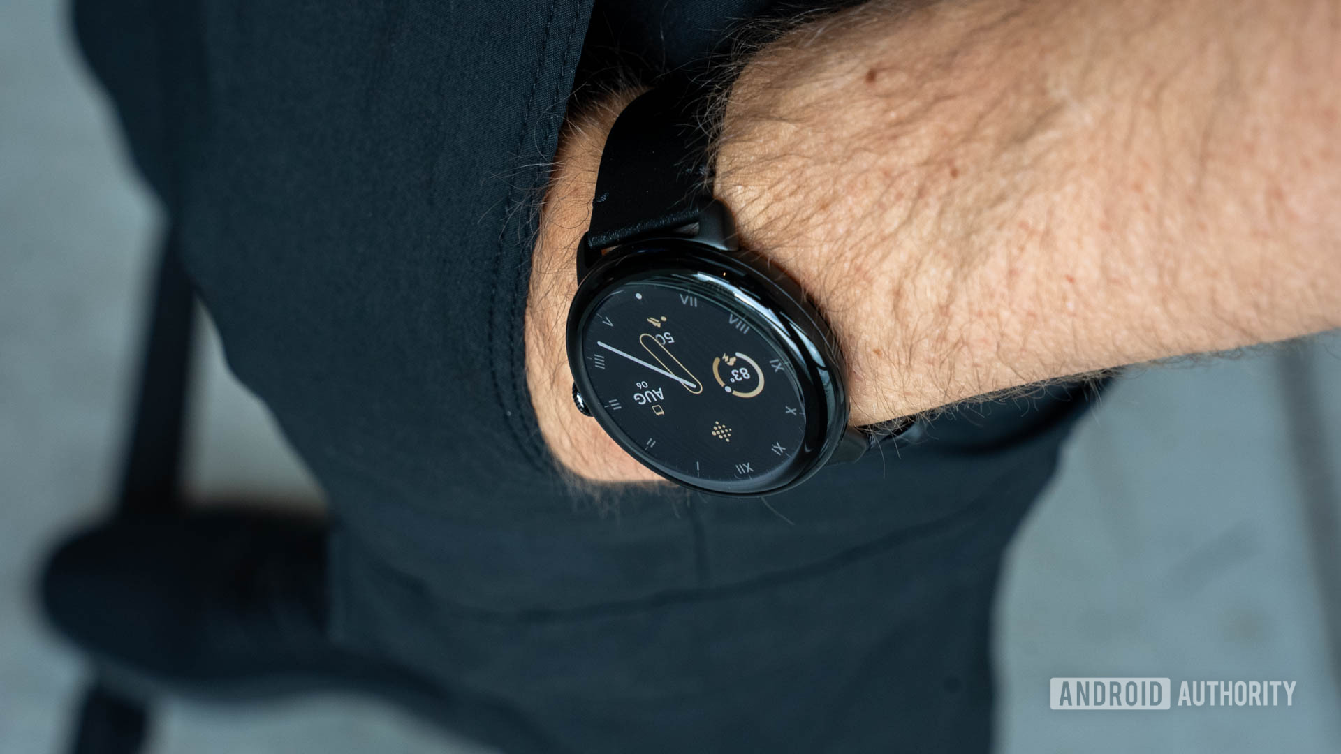 Google Pixel Watch 3 in 45mm size on person's left wrist as it rests in pants pocket